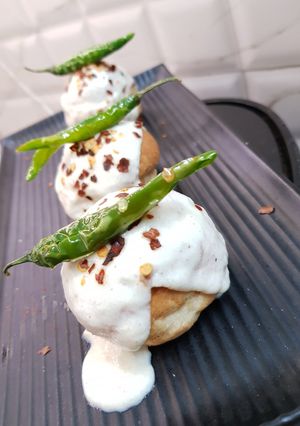 A picture of Stuffed vada pav with cheesy dip.