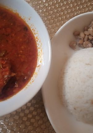 A picture of White rice, beans with dried fish stew.
