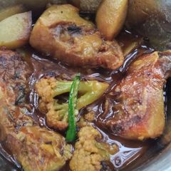 A picture of Fish curry with potatoes and cauliflower.