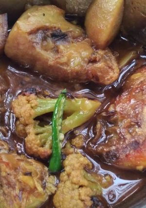 A picture of Fish curry with potatoes and cauliflower.