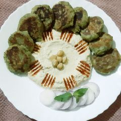 A picture of Falafel with hummus.