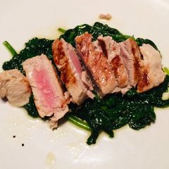 A picture of Grilled tuna with sauté spinach.