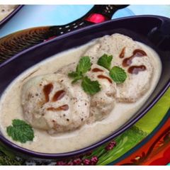 A picture of Dahi Bhalay - Pakistani style Fried Lentil Cakes in Sweet Yogurt Sauce.