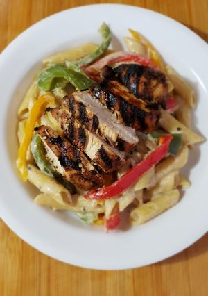A picture of Rasta Pasta with Grilled Jerk Chicken.