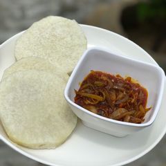 A picture of Boiled yam and palm oil sauce.