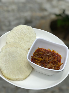 A picture of Boiled yam and palm oil sauce.