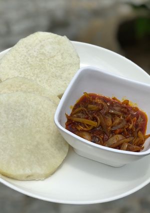 A picture of Boiled yam and palm oil sauce.