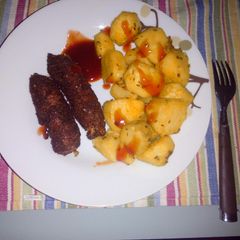 A picture of Roasted potatoes and coated smokies.
