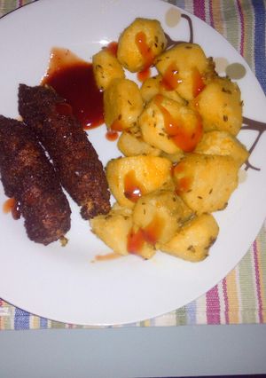 A picture of Roasted potatoes and coated smokies.
