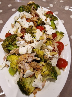 Una foto de Ensalada de brócoli, tomate cherry, pollo asado y queso fresco
