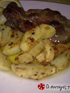 A picture of Beef Steaks with Potatoes in the Oven.