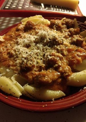 A picture of Italian sausage shells in spicy marinara cream sauce.