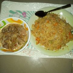 A picture of Jollof rice with pepper soup.