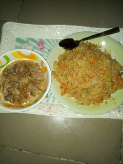 A picture of Jollof rice with pepper soup.