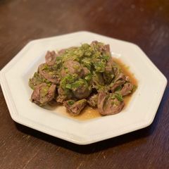 A picture of Chicken Hearts Yakitori style (no skewer) Leek Green on top.