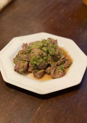 A picture of Chicken Hearts Yakitori style (no skewer) Leek Green on top.