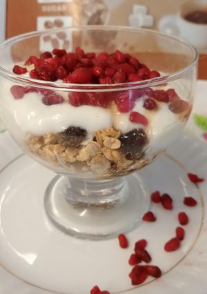 A picture of Super healthy breakfast bowl topped with pomegranate seeds.