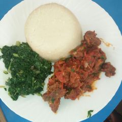Ugali nyama with greens A picture of Ugali nyama with greens.