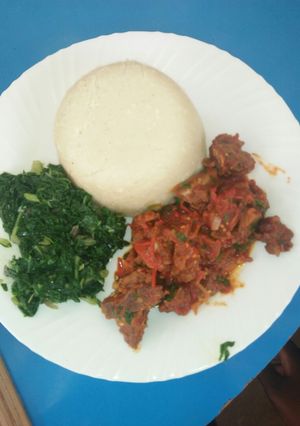 A picture of Ugali nyama with greens.
