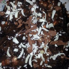 A picture of Molten lava chocolate nut cake with chocolate gratings....