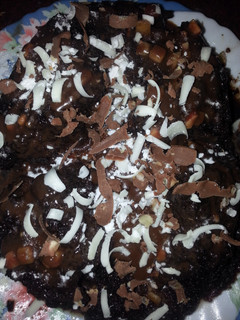A picture of Molten lava chocolate nut cake with chocolate gratings....