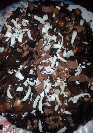 A picture of Molten lava chocolate nut cake with chocolate gratings....