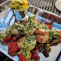 A picture of Char grilled scallops with mango avocado chimmichuri and veg.