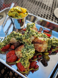 A picture of Char grilled scallops with mango avocado chimmichuri and veg.