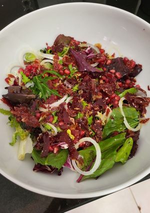 A picture of Salad with crispy Iberian ham and pomegranate.