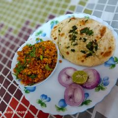 A picture of Bhurji Paneer With Garlic Naan.