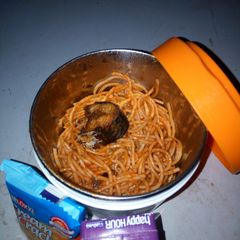 A picture of Jollof spaghetti with fried fish.