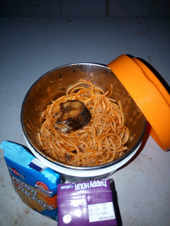 A picture of Jollof spaghetti with fried fish.