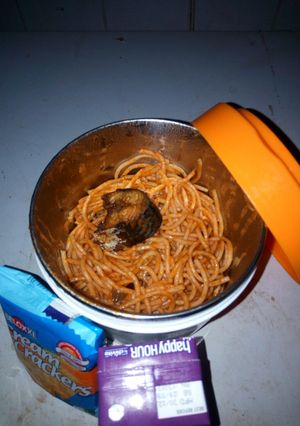 A picture of Jollof spaghetti with fried fish.