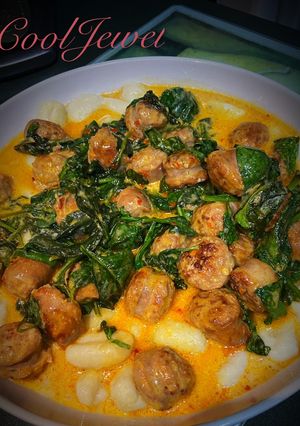 A picture of Italian Sausage with Gnocchi and Spinach.