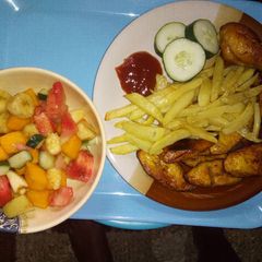 A picture of Chips, plantain with chicken N' Fruit salad!.