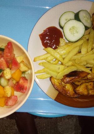 A picture of Chips, plantain with chicken N' Fruit salad!.