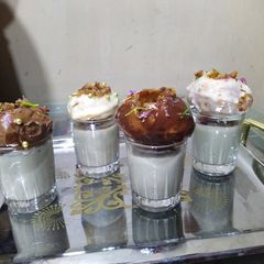 A picture of Golgappa dessert with paan shots.