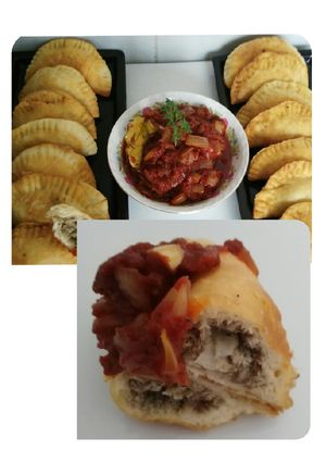 A picture of Sardine Empanadas with Tomato and Onion Sauce.