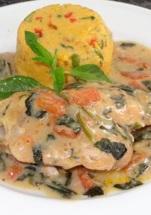 A picture of Tuscan Chicken Thighs with Polenta.