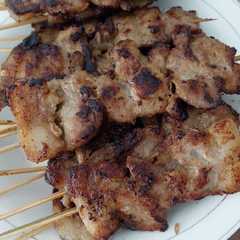 A picture of Moo ping/ Thai BBQ pork skewers.