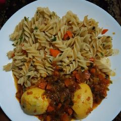 A picture of Macaroni and boiled eggs curry.