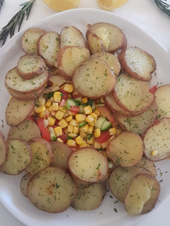 A picture of Roast potatoes with corn salad.