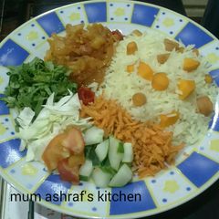 A picture of Rice with carrot and sauce.