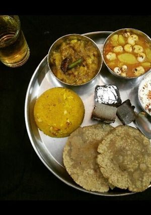 A picture of LUNCH-THALI Aloo Makhana,Namken kaddu,Jeera RaitaHalwa,JowarPuri.