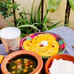 A picture of Sarsoon ka saagMakai ki RotiMakkhanLassi.