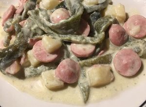 Una foto de Rajas con crema, papas y salchichas