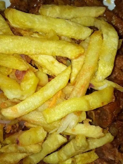 A picture of Stir fry beef with Fries.