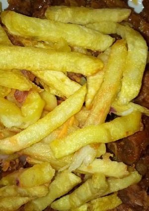 A picture of Stir fry beef with Fries.
