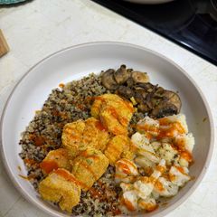 A picture of Fried Buffalo Shrimp over Quinoa with Sautéed Mushrooms and Cauliflower.