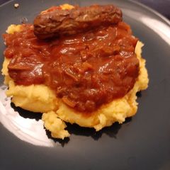 A picture of Polenta with mushrooms and sausages.